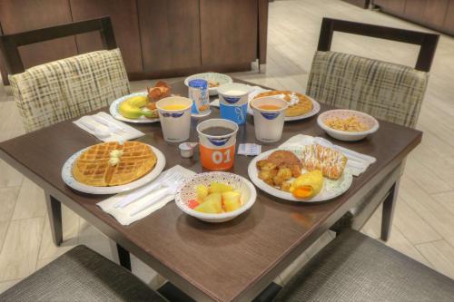 a wooden table topped with plates of breakfast food at Hampton Inn Gatlinburg Historic Nature Trail, Tn in Gatlinburg