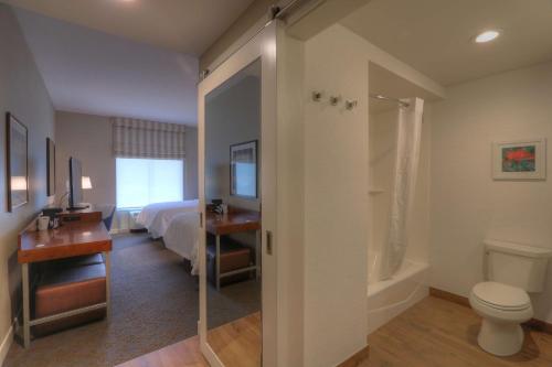 a hotel room with a bathroom with a bed and a toilet at Hampton Inn Gatlinburg Historic Nature Trail, Tn in Gatlinburg