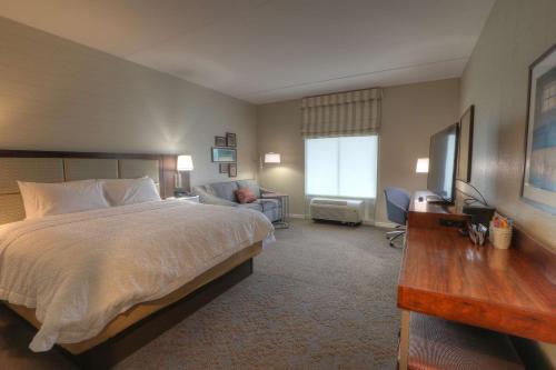 a hotel room with a large bed and a desk at Hampton Inn Gatlinburg Historic Nature Trail, Tn in Gatlinburg