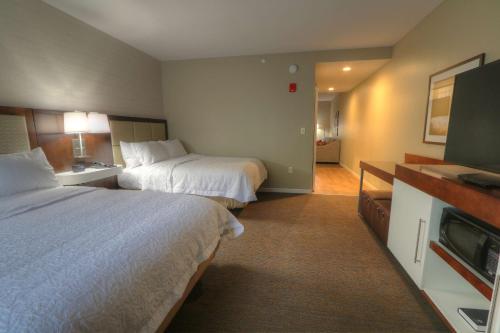 a hotel room with two beds and a flat screen tv at Hampton Inn Gatlinburg Historic Nature Trail, Tn in Gatlinburg