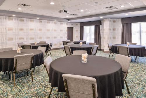 a banquet room with tables and chairs with black table cloths at Hampton Inn Emporia, KS in Emporia