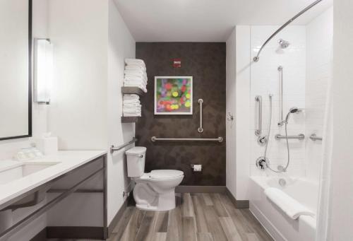 a white bathroom with a toilet and a shower at Hilton Garden Inn Ft. Walton Beach in Fort Walton Beach