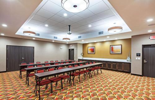a conference room with rows of tables and red chairs at Hampton Inn & Suites Houston/Atascocita, Tx in Humble