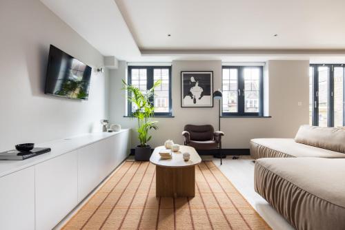 a living room with a couch and a table at Covent Garden Apartments in London