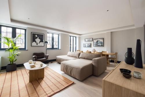 a living room with a couch and a table at Covent Garden Apartments in London
