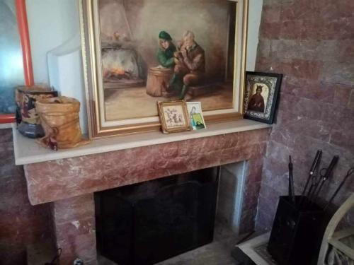 a fireplace with a painting on top of it at Villa Margarita in Chalkida