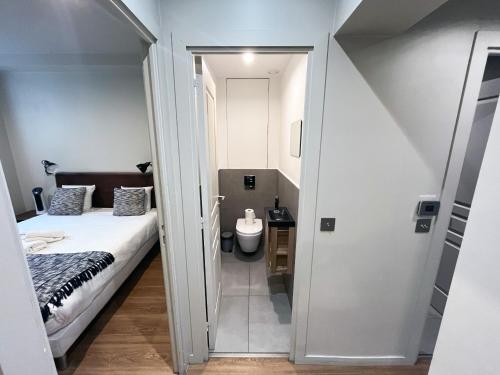 a small room with a bed and a bathroom at 78 - Urban Beautiful Le Marais in Paris