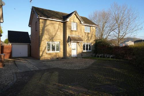 a large house with a driveway in front of it at Cosy Stirling 3-bedroom Home in Stirling