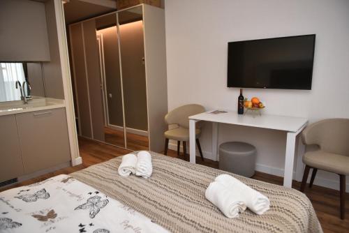 a hotel room with a bed with towels on it at Premium apartments - the star of Batumi Palace in Batumi