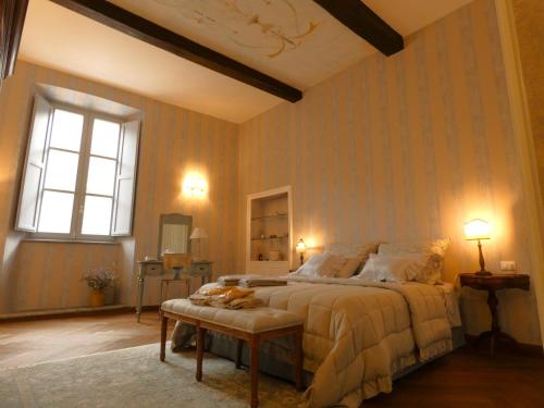 a bedroom with a large bed and a window at Scappo in Umbria, Residenza Monaldeschi in Orvieto