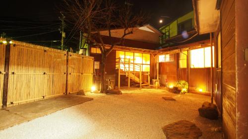 a room with a fence and a building at night at 2 separate houses※Garden/Hakone 3min walk from Sta in Hakone
