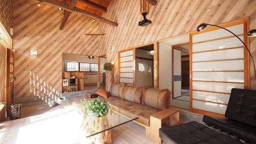 a living room with a couch and a table at 2 separate houses※Garden/Hakone 3min walk from Sta in Hakone