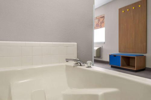 a bathroom with a white tub and a sink at Days Inn by Wyndham Washington Court House in Washington Court House