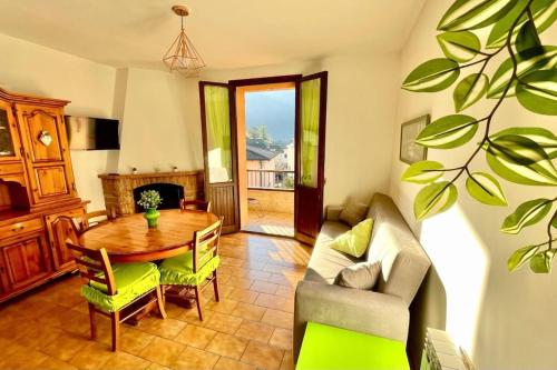 a living room with a table and a couch at Terrazza Rinaldi - centro - wifi - Panoramico in Fanano