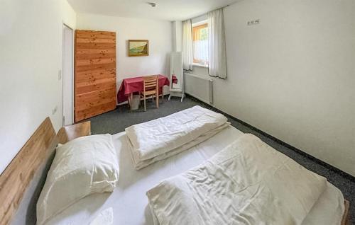 a bedroom with two beds and a table in it at Nice Apartment In Navis With House A Mountain View in Navis