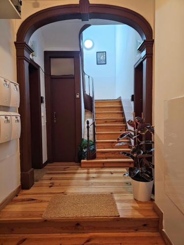 an archway leading into a hallway with a staircase at Vila Queirós, 6 in Lisbon