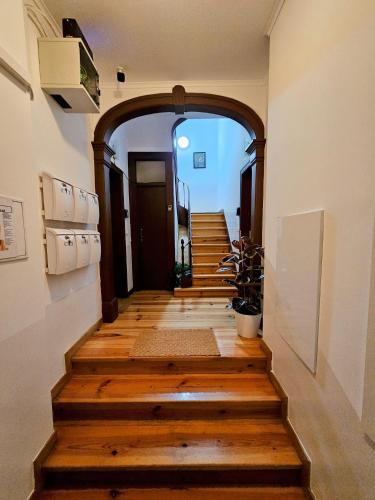 an archway leading up to a hallway with wooden floors at Vila Queirós, 6 in Lisbon