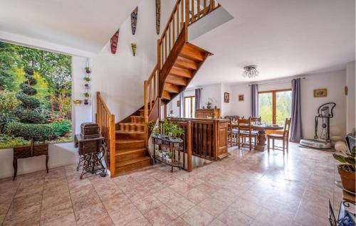 a living room with a staircase and a dining room at Cozy Home In Le Vaumain With Kitchen in Le Vaumain