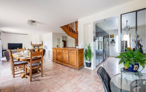 a dining room and living room with a table and chairs at Cozy Home In Le Vaumain With Kitchen in Le Vaumain