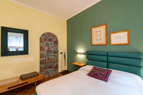 a bedroom with a bed and a door with a window at sunny courtyard in Piombino