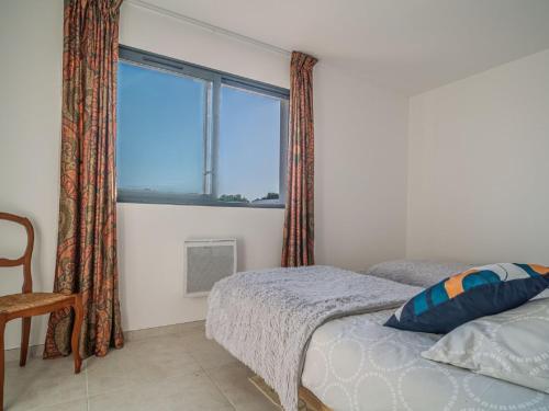 a bedroom with a bed and a large window at Holiday Home Aubépines by Interhome in Sainte-Marie-la-Mer
