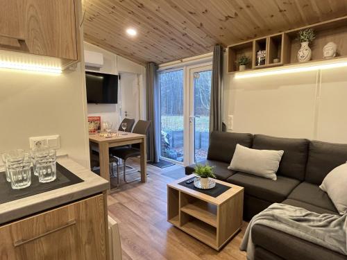 a living room with a couch and a table at Holiday Home Seeblick by Interhome in Wemding