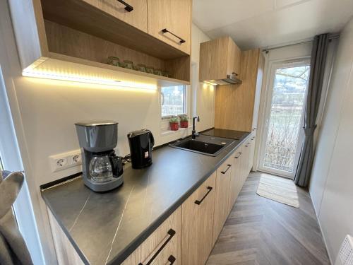 a kitchen with a coffee maker on a counter at Holiday Home Tiny Haus Altmühlblick II by Interhome in Riedenburg