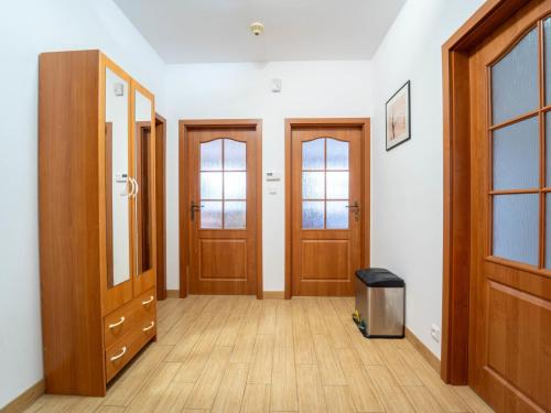 an empty hallway with wooden doors and a trash can at Holiday Home Vrbová Lhota U Aničky by Interhome in Vrbová Lhota