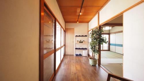 a hallway with a potted plant in a building at 2 separate houses※Garden/Hakone 3min walk from Sta in Hakone