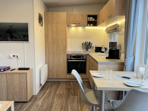 a small kitchen with a table and a dining room at Holiday Home Paul by Interhome in Wemding