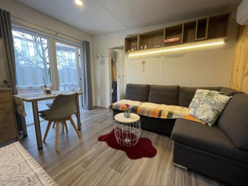 a living room with a couch and a table at Holiday Home Renate by Interhome in Wemding