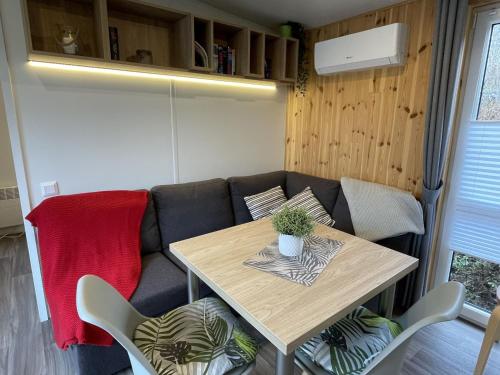 a living room with a table and a couch at Holiday Home Tiny Haus Motte by Interhome in Wemding