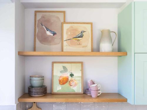 a shelf with three pictures of birds on it at Soloandie Casa rural in Zeanuri