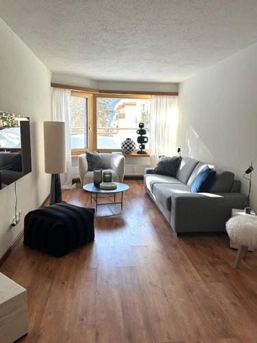 a living room with a couch and a table at Wonderful cosy apartment in St. Moritz in St. Moritz