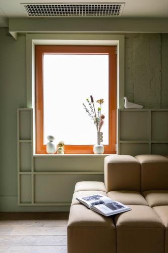 a living room with a couch and a window at Locke at Broken Wharf in London