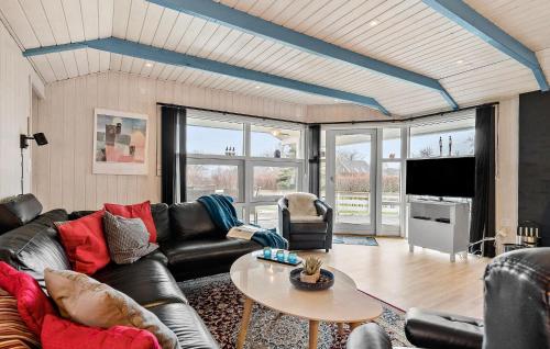 a living room with a couch and a table at Holiday Home Slåenvænget Hejls X Denmark in Hejls