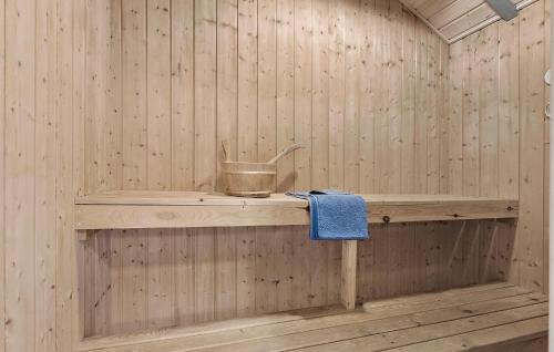 a sauna with a bucket on a wooden shelf at Holiday Home Slåenvænget Hejls X Denmark in Hejls