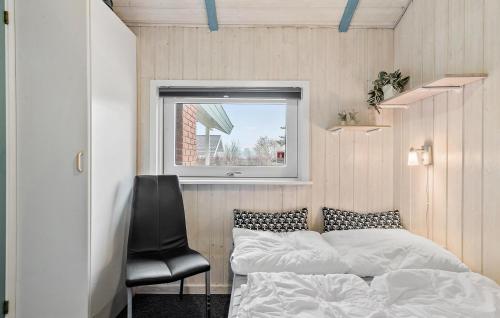 HejlsにあるCozy Home In Hejls With Saunaのベッドルーム1室(ベッド1台、黒い椅子付)