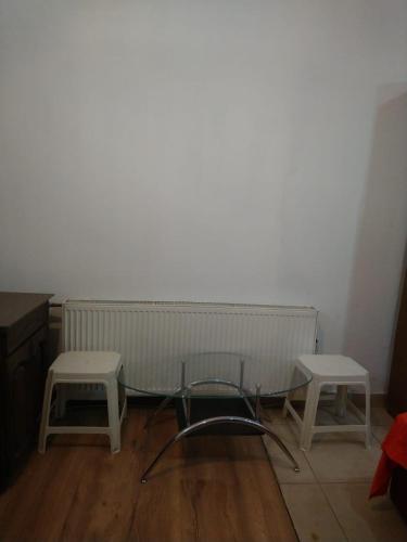 a living room with two tables and a radiator at Stan Petrovac na Mlavi ( 10km od Banje Ždrelo ) in Petrovac na Mlavi