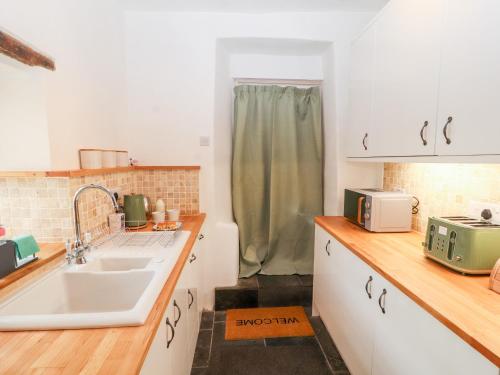 a kitchen with a sink and a sink at Natland Hall Cottage in Kendal