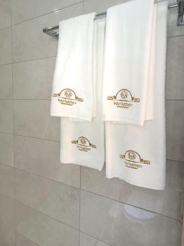 a group of towels are hanging in a bathroom at Navarino Luxe Suites in Perea