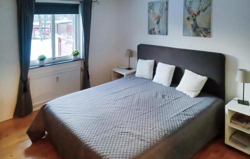 a bedroom with a large bed with two pillows at Nice Apartment In Hyltebruk With 2 Bedrooms And Wifi in Hyltebruk