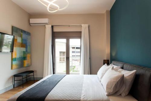 a bedroom with a bed with a large window at Minimal Loft Art with Sea View Over Heraklion Harbour in Heraklio Town