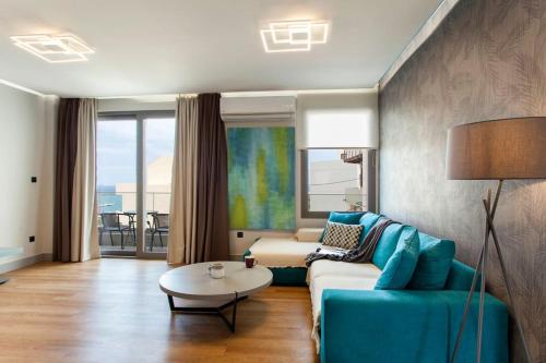 a living room with a couch and a table at Minimal Loft Art with Sea View Over Heraklion Harbour in Heraklio