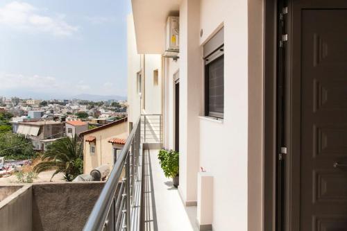 a balcony with a view of a city at Minimal Loft Art with Sea View Over Heraklion Harbour in Heraklio Town