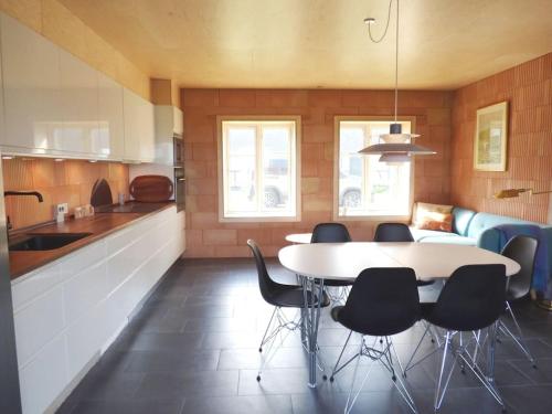 a kitchen with a table and chairs in a room at Klintgarden in Martofte