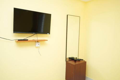 a flat screen tv hanging on a wall at H2 Residency in Rāmanāthapuram
