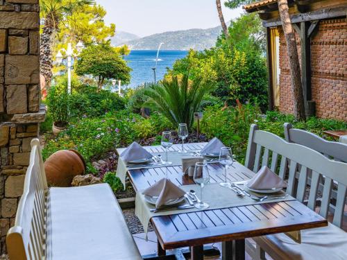 a table and chairs on a patio with a view of the ocean at Labranda Mares Marmaris Hotel in Marmaris