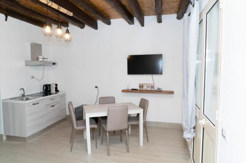 a kitchen and dining room with a table and chairs at Politeama house in Palermo