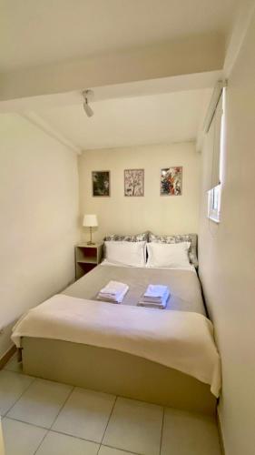 a bedroom with a bed with two towels on it at Chiado Apartment with Terrace 1 in Lisbon